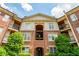 Elegant brick condominium exterior featuring balconies and manicured landscaping at 825 Highland Ne Ln # 1116, Atlanta, GA 30306