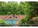 Community pool area with brick walls, lounge chairs and mature trees surrounding at 825 Highland Ne Ln # 1116, Atlanta, GA 30306