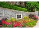 Stone community sign with colorful flowerbed at The Carlton, Atlanta at 825 Highland Ne Ln # 1116, Atlanta, GA 30306