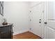 Clean entryway with hardwood floors, a white door, and a decorative table at 825 Highland Ne Ln # 1116, Atlanta, GA 30306