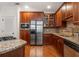 Gourmet kitchen featuring stainless steel appliances, granite countertops, and wooden cabinetry at 825 Highland Ne Ln # 1116, Atlanta, GA 30306