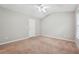 Neutral carpeted bedroom featuring light gray walls, white trim, and a ceiling fan at 9165 Nesbit Ferry Rd # 9, Alpharetta, GA 30022