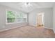 Bright bedroom with neutral walls, carpet, a ceiling fan, and several windows at 9165 Nesbit Ferry Rd # 9, Alpharetta, GA 30022