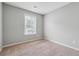 Cozy bedroom with neutral walls, plush carpet, and a window providing natural light at 9165 Nesbit Ferry Rd # 9, Alpharetta, GA 30022