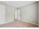 Bright bedroom featuring neutral walls, carpet, and white doors leading to other rooms at 9165 Nesbit Ferry Rd # 9, Alpharetta, GA 30022