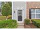 Inviting front door with decorative trim, surrounded by lush greenery and classic exterior details at 9165 Nesbit Ferry Rd # 9, Alpharetta, GA 30022