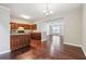 Open kitchen with dark wood cabinetry, stainless steel appliances, and hardwood floors connecting to the living area at 9165 Nesbit Ferry Rd # 9, Alpharetta, GA 30022