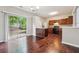 Modern kitchen with hardwood floors, stainless steel appliances, dark cabinetry, and access to the backyard at 9165 Nesbit Ferry Rd # 9, Alpharetta, GA 30022