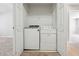 Convenient laundry closet featuring a side-by-side washer and dryer setup with storage shelf above at 9165 Nesbit Ferry Rd # 9, Alpharetta, GA 30022