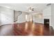 Open living room with hardwood floors, fireplace, staircase, and seamless flow to the dining area at 9165 Nesbit Ferry Rd # 9, Alpharetta, GA 30022