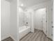 Bright white bathroom with a tub and shower, complemented by modern tile and fixtures at 110 Beaver Pointe, Villa Rica, GA 30180