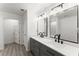 Modern bathroom featuring double sink vanity, sleek mirrors, and stylish black fixtures at 110 Beaver Pointe, Villa Rica, GA 30180