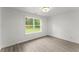Sunlit bedroom with a nature view, showcasing light wood-look flooring, and neutral walls at 110 Beaver Pointe, Villa Rica, GA 30180