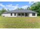 Rear exterior of a modern home showcasing clean lines, large windows, and a well-maintained lawn at 110 Beaver Pointe, Villa Rica, GA 30180
