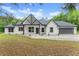 Charming craftsman-style home with white siding, black trim and a well-manicured lawn at 110 Beaver Pointe, Villa Rica, GA 30180