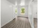 Bright living room with wood-look flooring and natural light streaming through the windows at 110 Beaver Pointe, Villa Rica, GA 30180