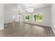 Spacious living room featuring wood-look floors, natural lighting, and an elegant chandelier at 110 Beaver Pointe, Villa Rica, GA 30180