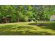 Large backyard featuring an outbuilding and a fire pit at 19 Margrit Ct, Stockbridge, GA 30281