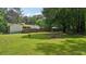Extensive backyard showcasing the house, screened porch, and fire pit at 19 Margrit Ct, Stockbridge, GA 30281
