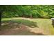 Well-maintained backyard with a fire pit surrounded by lush greenery at 19 Margrit Ct, Stockbridge, GA 30281