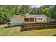Inviting backyard with a wooden deck, screen porch, and wood fence at 19 Margrit Ct, Stockbridge, GA 30281
