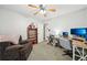 Functional bedroom featuring neutral tones, a ceiling fan, and comfortable seating at 19 Margrit Ct, Stockbridge, GA 30281