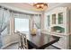 Bright dining room featuring a bay window, modern chandelier, and stylish decor for elegant entertaining at 19 Margrit Ct, Stockbridge, GA 30281