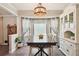 Inviting dining room with elegant lighting, a large table, and a stylish hutch at 19 Margrit Ct, Stockbridge, GA 30281
