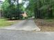 Secluded brick home with a long driveway surrounded by mature trees and lush greenery at 19 Margrit Ct, Stockbridge, GA 30281