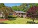 Charming brick home with a covered front porch and lush landscaping at 19 Margrit Ct, Stockbridge, GA 30281