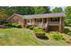 Charming brick home with a covered front porch and well-maintained landscaping at 19 Margrit Ct, Stockbridge, GA 30281