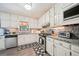 Well-lit kitchen features white cabinets, granite countertops, and stainless steel appliances at 19 Margrit Ct, Stockbridge, GA 30281