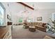 Spacious living room with large sectional, vaulted ceiling, and view to adjoining breakfast area at 19 Margrit Ct, Stockbridge, GA 30281