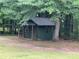 Charming outbuilding nestled in a peaceful, wooded backyard at 19 Margrit Ct, Stockbridge, GA 30281