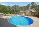 Backyard pool with concrete surround and mature trees providing ample shade and privacy at 19 Margrit Ct, Stockbridge, GA 30281