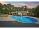Backyard oasis featuring a large in-ground pool, deck, and lush landscaping perfect for entertaining at 19 Margrit Ct, Stockbridge, GA 30281