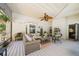 Cozy screened porch featuring comfortable seating, a ceiling fan, and outdoor decor at 19 Margrit Ct, Stockbridge, GA 30281