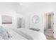 Clean bedroom featuring white walls, hardwood floors, king bed with a bathroom view, and lots of light at 3316 Stillwood Ln, Atlanta, GA 30354