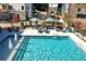 Community pool featuring water fountains, lounge chairs, and tables with umbrellas for outdoor relaxation at 3316 Stillwood Ln, Atlanta, GA 30354