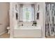 Relaxing bathroom with soaking tub, elegant fixtures, and natural light at 35 Kendall Ln, Covington, GA 30014