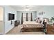 Primary bedroom features a ceiling fan, a TV, neutral paint and a comfortable bed at 35 Kendall Ln, Covington, GA 30014