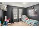 Cozy bedroom with playful decor, dark walls and a window with lots of natural light at 35 Kendall Ln, Covington, GA 30014