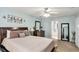 Bedroom with ceiling fan, neutral paint, and comfortable bed at 35 Kendall Ln, Covington, GA 30014