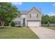Charming two-story home with green door, well-maintained lawn, and attached two-car garage at 35 Kendall Ln, Covington, GA 30014