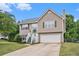Charming two-story home with green door, well-maintained lawn, and attached two-car garage at 35 Kendall Ln, Covington, GA 30014