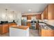 Spacious kitchen with stainless steel appliances, wood cabinets, butcher block island, and modern lighting at 35 Kendall Ln, Covington, GA 30014
