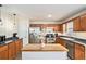 Bright eat-in kitchen with island, wood cabinetry, stainless appliances, recessed lights, and modern finishes at 35 Kendall Ln, Covington, GA 30014