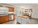 Charming eat-in kitchen features a butcher block island, stainless steel appliances, and wood cabinetry at 35 Kendall Ln, Covington, GA 30014