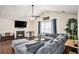 Bright and airy living room featuring a cozy fireplace, plush sectional sofa, and hardwood flooring at 35 Kendall Ln, Covington, GA 30014