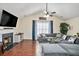 Bright and airy living room featuring a cozy fireplace, plush sectional sofa, and hardwood flooring at 35 Kendall Ln, Covington, GA 30014